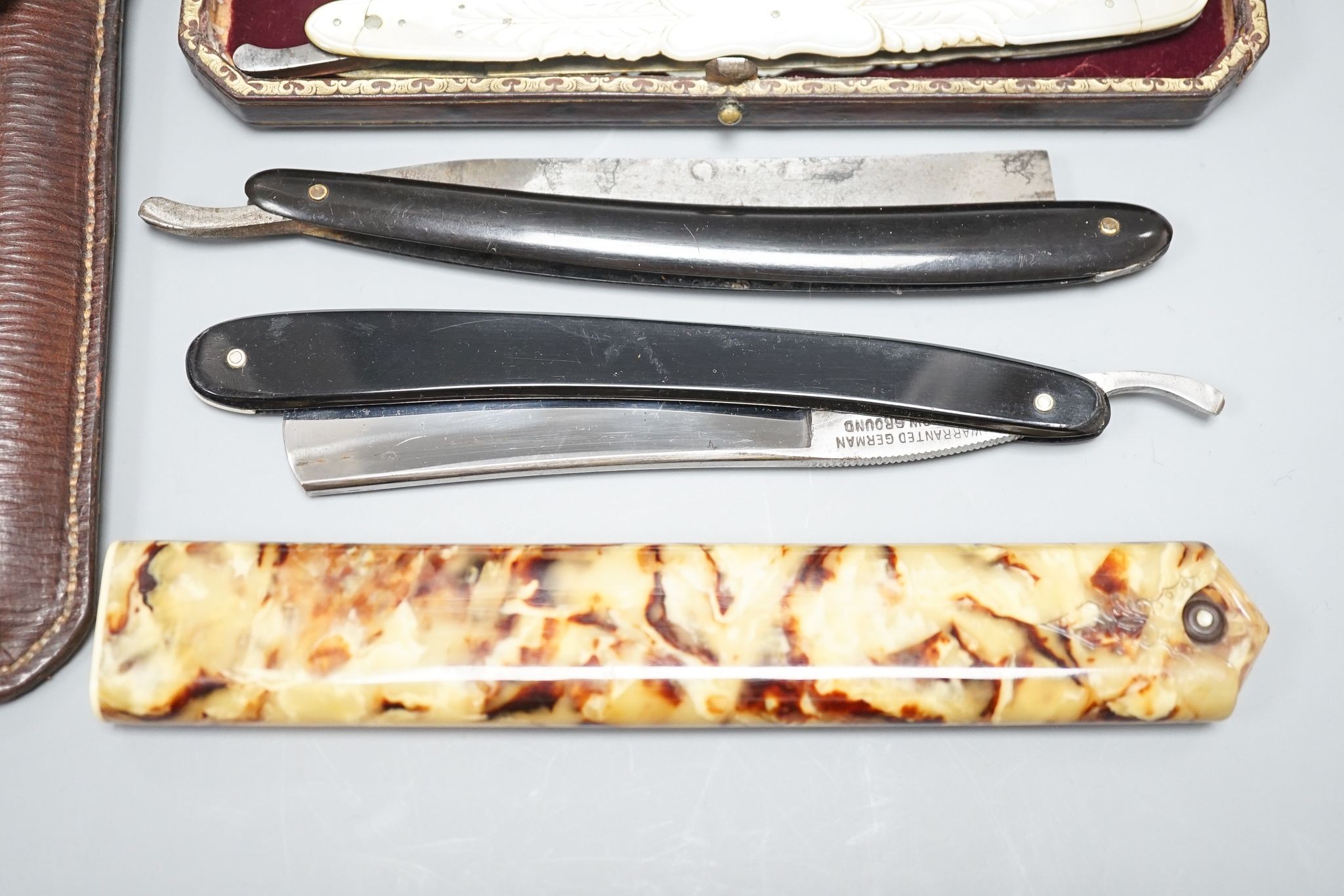 A leather cased pair of mother-of-pearl handled cut throat razors, by J Crawford and three other cased cut throat razors (4)